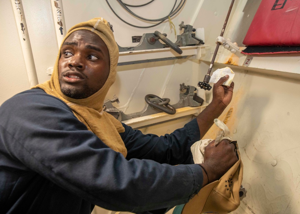 Sailor Checks Valves During Damage Control Drill