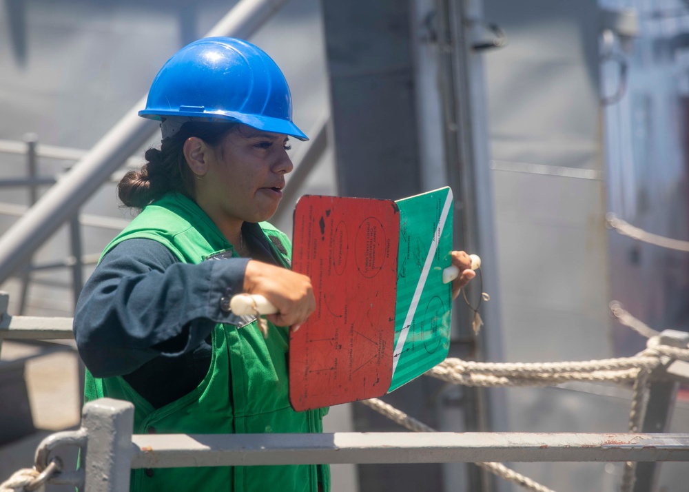 Sailor Signals USNS Alan Shepard During Replenishment At Sea