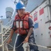 Sailor Heaves Line During Replenishment At Sea