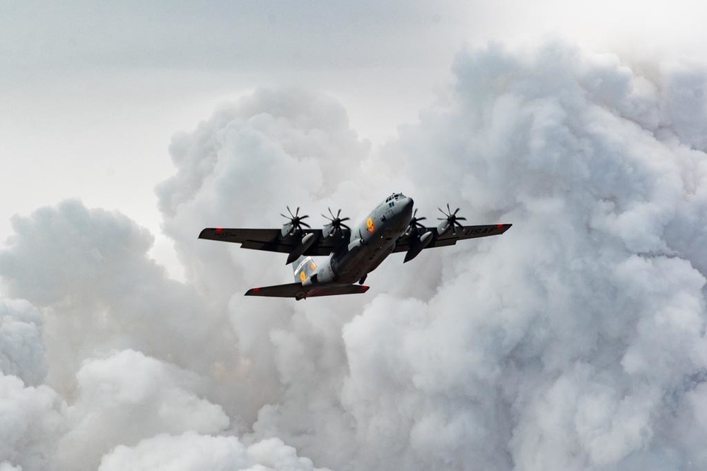 Air National Guard C-130 over plumes of smoke from the Beckwourth Complex Fire July 9, 2021 near Frenchman Lake in N. California