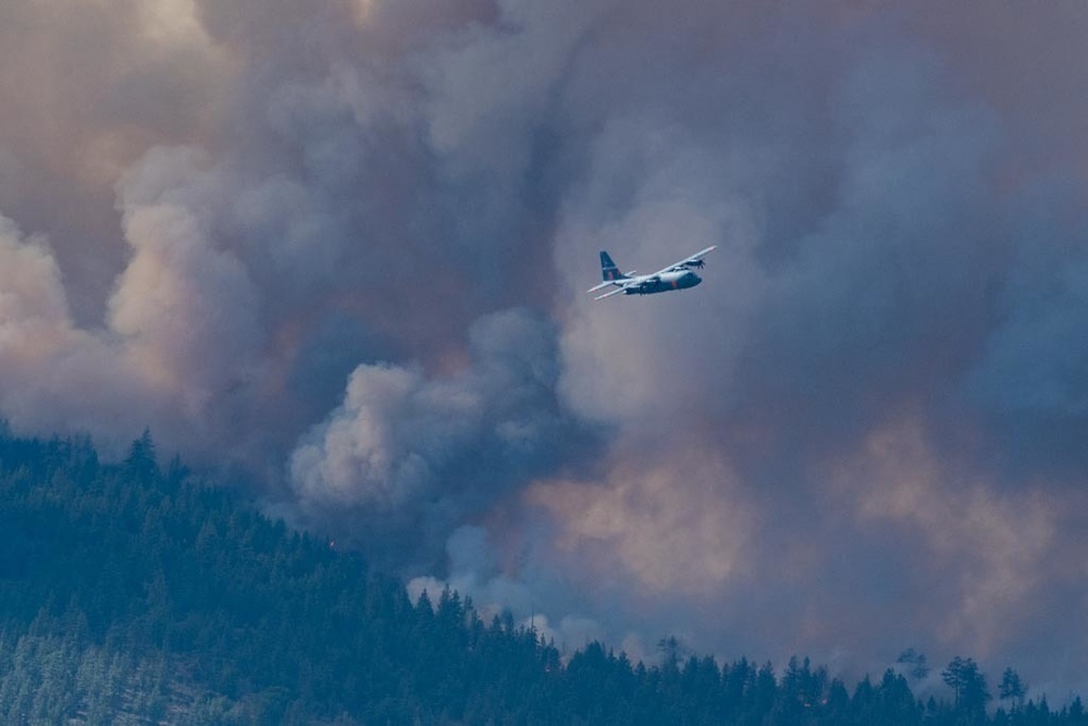 Air National Guard C-130, MAFFS 9 out of Reno, Nev. flying over the plumes of smoke from the Beckwourth Complex Fire July 9, 2021 near Frenchman Lake in N. California