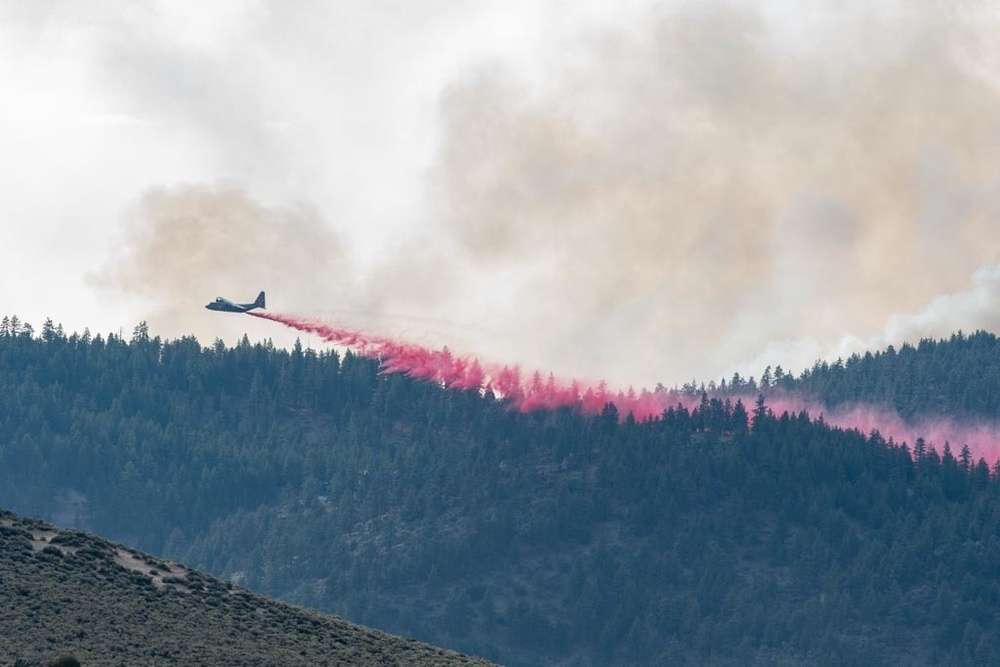 Air National Guard C-130 drops retardant on the Beckwourth Complex Fire July 9, 2021 near Frenchman Lake in N. California