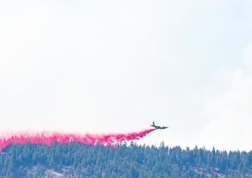 Air National Guard C-130 drops retardant on the Beckwourth Complex Fire July 9, 2021 near Frenchman Lake in N. California