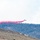 Air National Guard C-130 drops retardant on the Beckwourth Complex Fire July 9, 2021 near Frenchman Lake in N. California