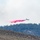 Air National Guard C-130 drops retardant on the Beckwourth Complex Fire July 9, 2021 near Frenchman Lake in N. California