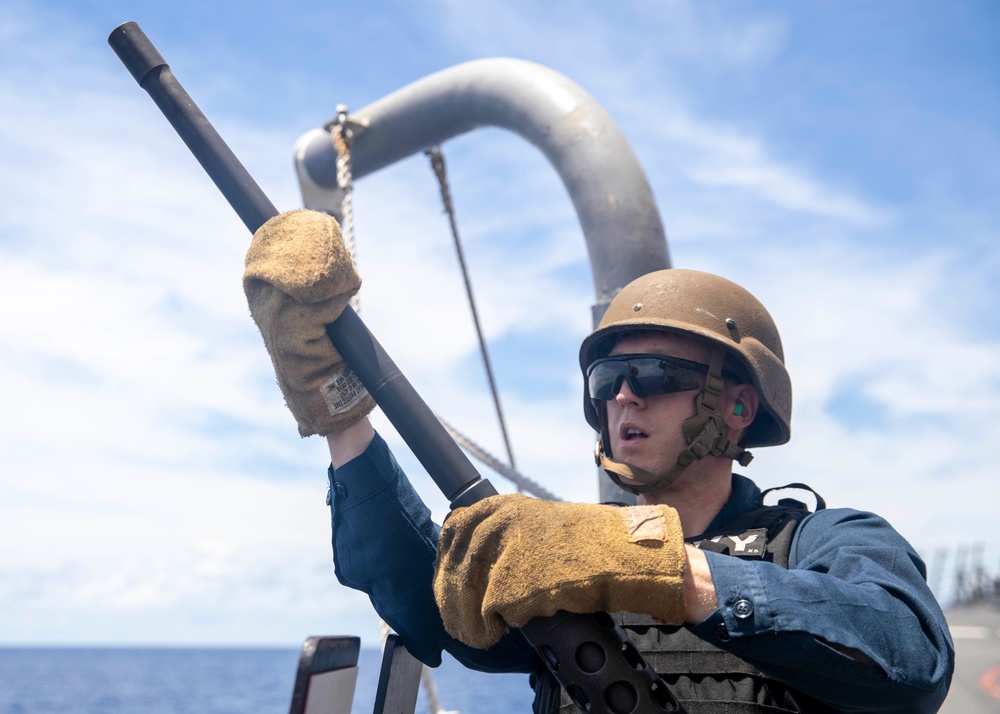 Sailor Removes Machine Gun Barrel