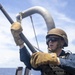 Sailor Removes Machine Gun Barrel