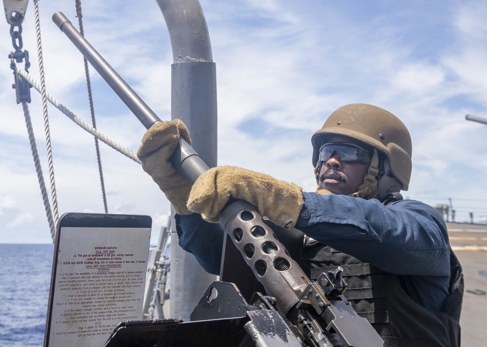 Sailor Removes Machine Gun Barrel