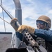 Sailor Removes Machine Gun Barrel