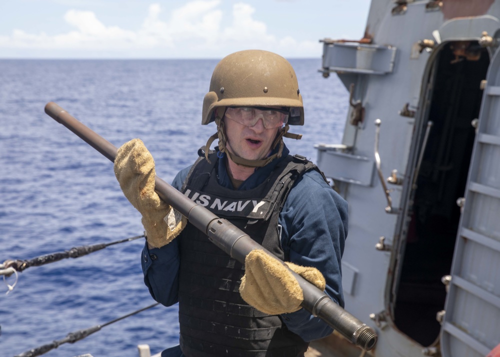 Sailor Removes Machine Gun Barrel