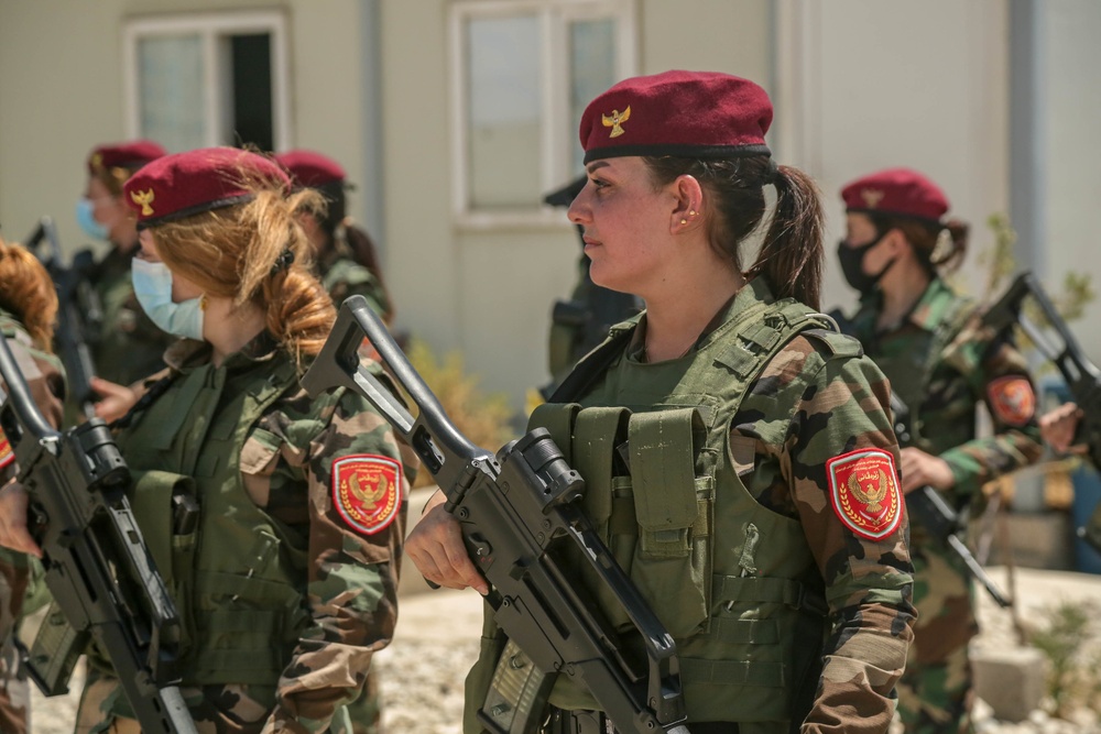 Peshmerga female soldiers run through squad movement drills a