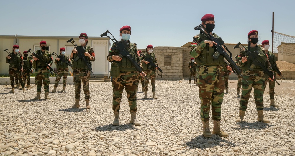 Peshmerga female soldiers run through squad movement drills