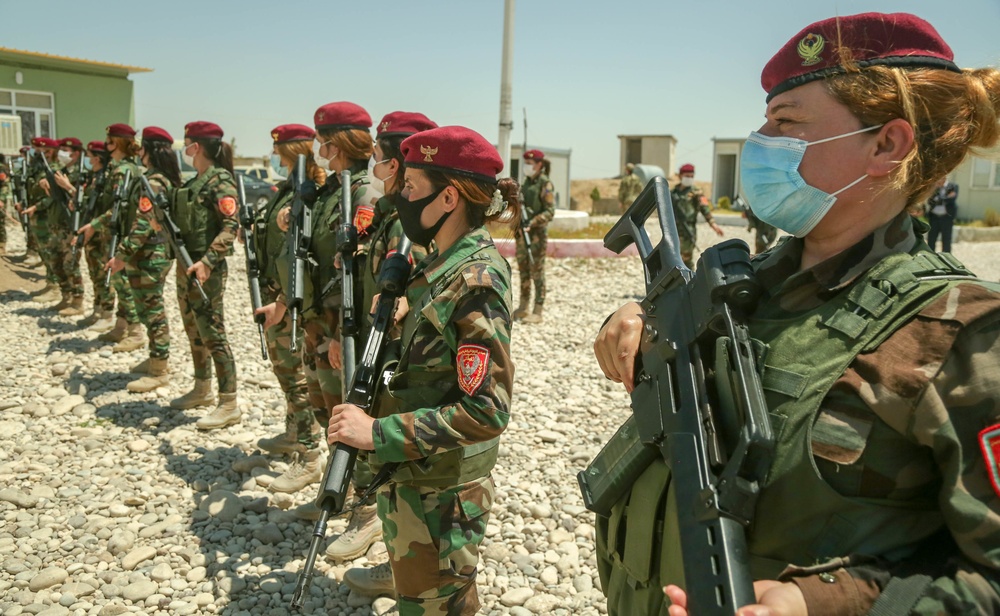 Peshmerga female soldiers run through squad movement drills