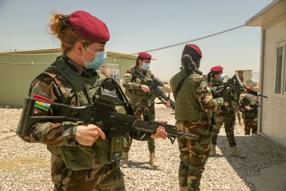 Peshmerga female soldiers run through squad movement drills