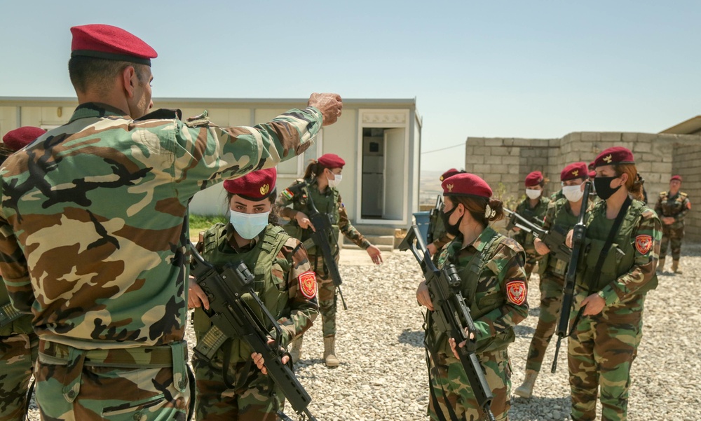 Peshmerga female soldiers run through squad movement drills