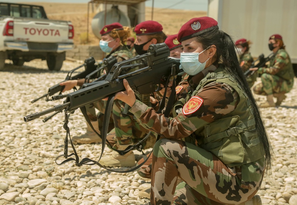 Peshmerga female soldiers run through squad movement drills