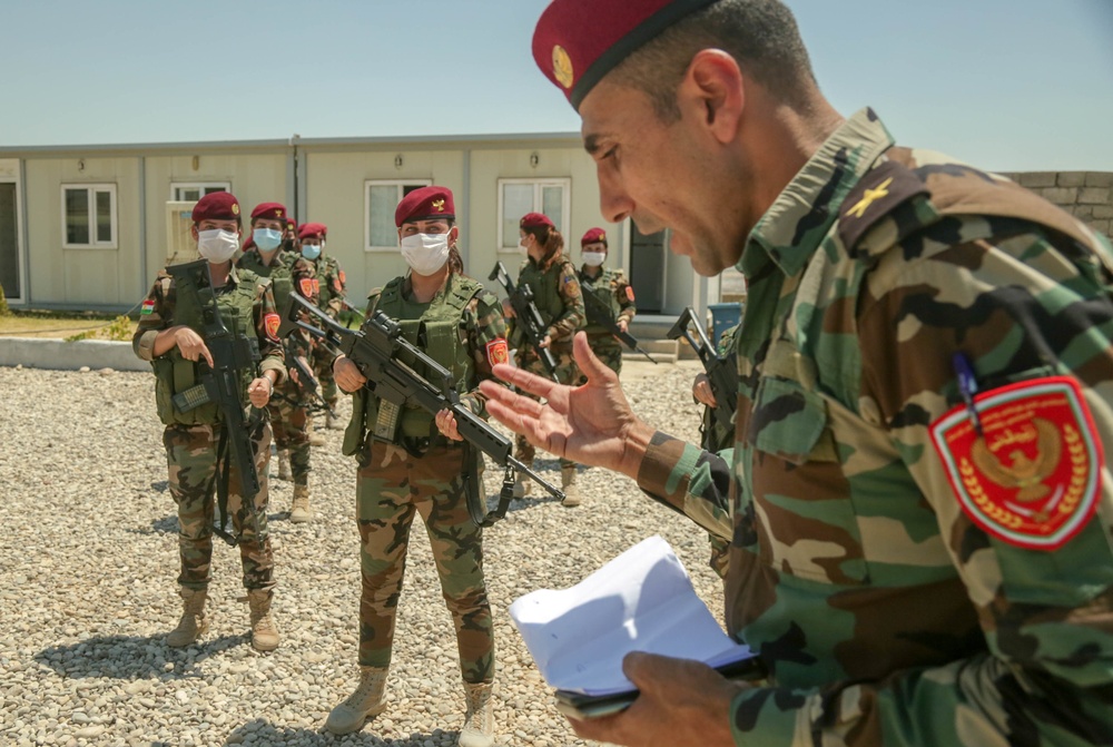 Peshmerga female soldiers run through squad movement drills