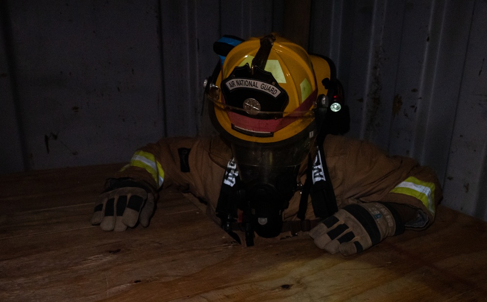 GOING IN BLIND AND LOW: 152nd CES Firefighters show off their confidence in SCBA confined space confidence course