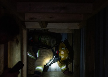 GOING IN BLIND AND LOW: 152nd CES Firefighters show off their confidence in SCBA confined space confidence course