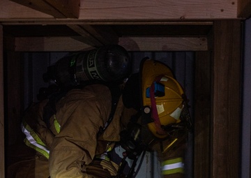 GOING IN BLIND AND LOW: 152nd CES Firefighters show off their confidence in SCBA confined space confidence course