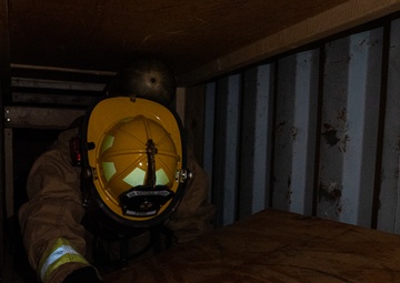 GOING IN BLIND AND LOW: 152nd CES Firefighters show off their confidence in SCBA confined space confidence course