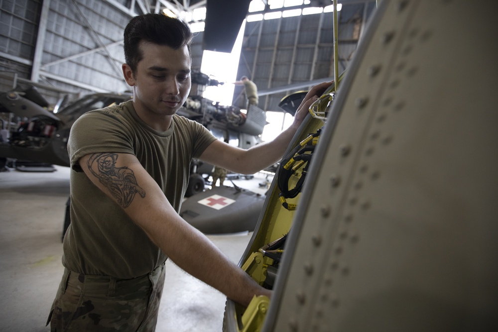 Marne Air Soldiers conduct phase maintenance on a CH-47 Chinook helicopter.