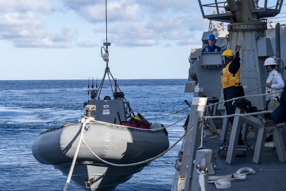 Sailors prepare to launch a ridged-hull inflatable boat (RHIB)