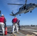 Sailors prepare to conduct a helo in-flight refueling (HIFI) with an MH-60R Seahawk