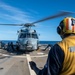 Sailors secures chocks and chains to an MH-60R Seahawk