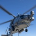 Sailors secure equipment to an MH-60R Seahawk