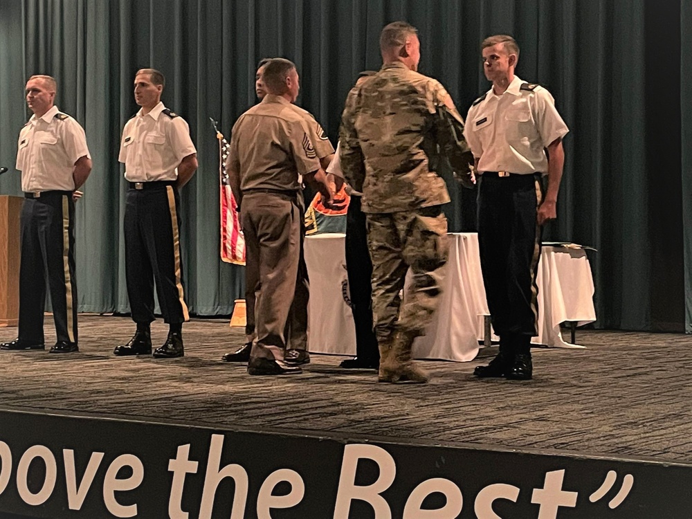 Brig. Gen. Budraitis presents coins to SLC Distinguished Honor Grad and Commandant's List