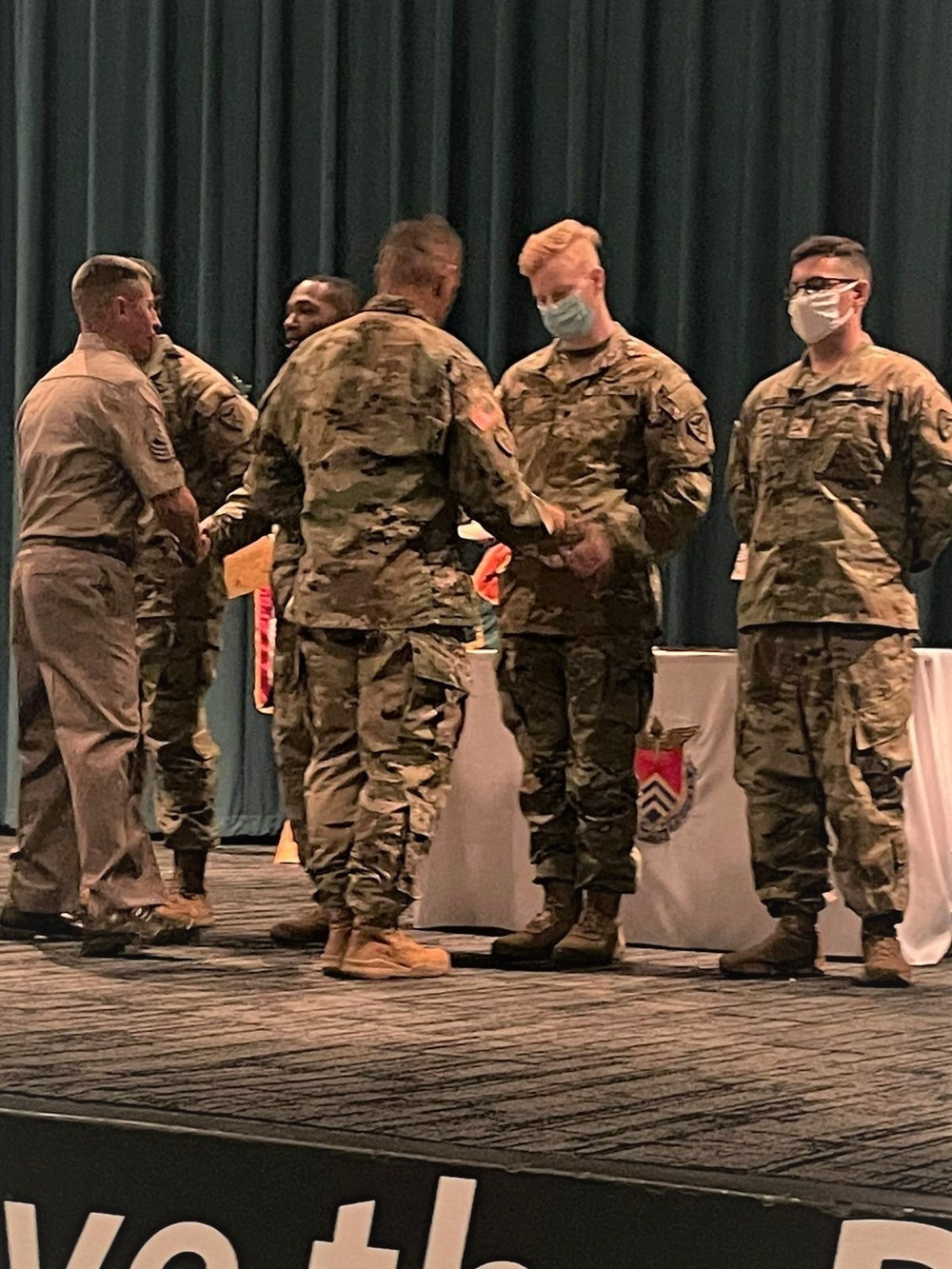 Brig. Gen. Budraitis presents coins to SLC Distinguished Honor Grad and Commandant's List