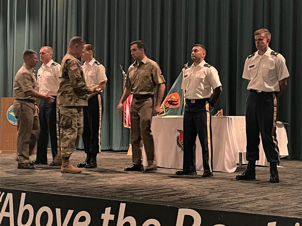 Brig. Gen. Budraitis presents coins to SLC Distinguished Honor Grad and Commandant's List