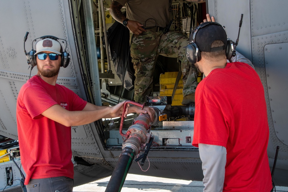 CAL FIRE employees load retardant into an Air National Guard C-130 from McClellan Air Tanker Base, Sacramento, Calif.