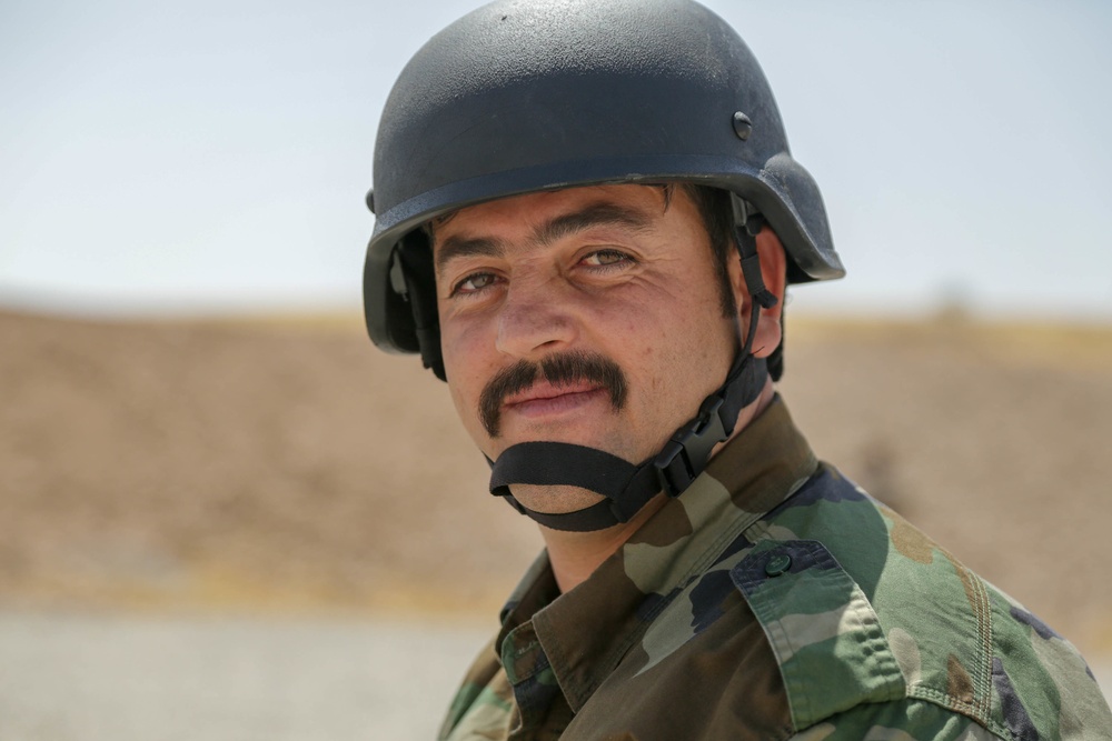 Peshmerga soldier conducts shooting training with an M249