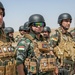 Peshmerga soldiers stand in formation