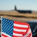 The U.S. Flag waves in the wind as a California Air National Guard C-130 taxis to the runway at McClellan Air Tanker Base, Sacramento, Calif.