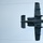 A military jet aircraft is photographed from below as it flies overhead against an overcast sky. The aircraft is viewed from a bottom-up perspective, revealing its underside configuration including twin engines mounted on the rear fuselage and a distinctive twin-tail design consistent with an A-10 Thunderbolt II. Two thin contrail or vapor lines are visible stretching horizontally across the upper portion of the image.