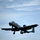A U.S. Air Force A-10 Thunderbolt II (Warthog) attack aircraft is photographed in flight against a partly cloudy blue sky. The aircraft has its landing gear deployed, suggesting it is either on approach for landing or shortly after takeoff. Tail code 'DM' and fuselage number '240' are visible, indicating assignment to Davis-Monthan Air Force Base.