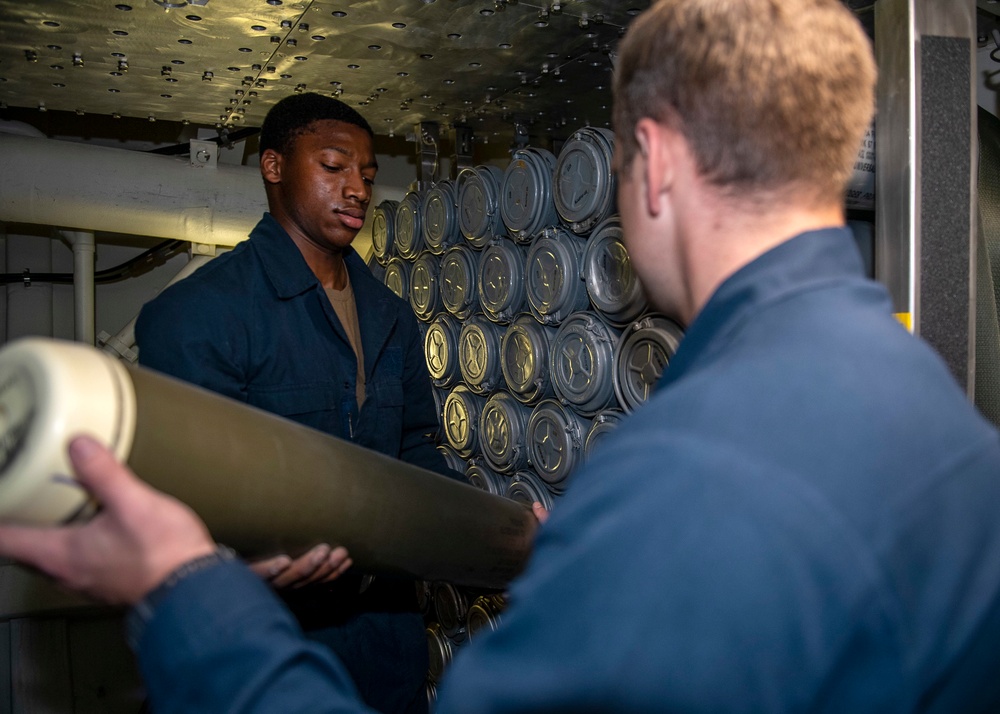 Sailors prepare to load 5-inch gun ammunition