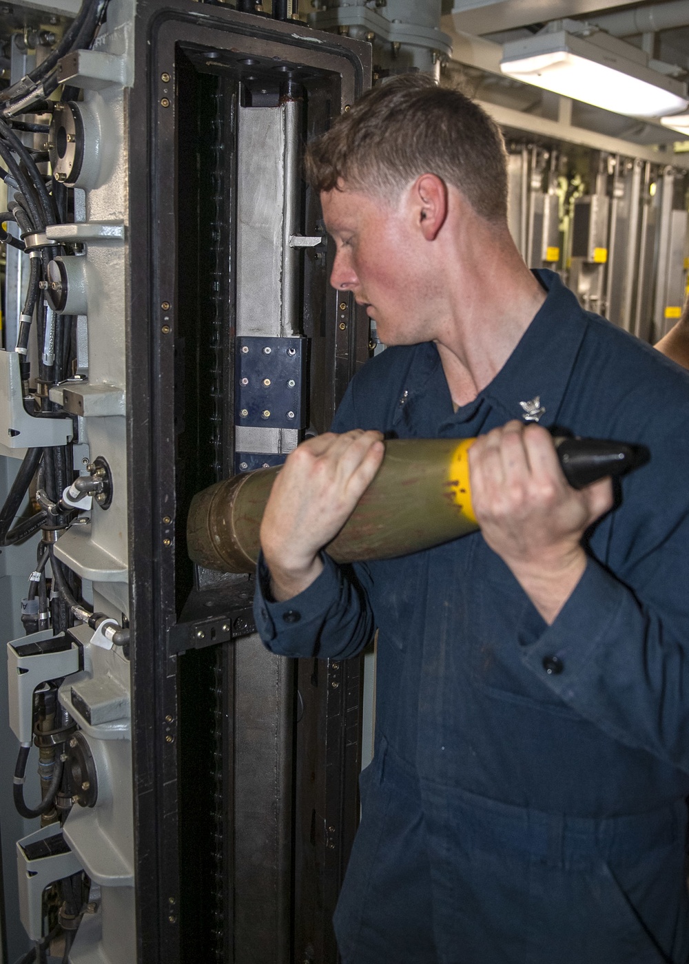 Gunner’s Mate 2nd Class Ryan Michael, from Shenandoah, Va., loads ammunition into the 5-inch gun