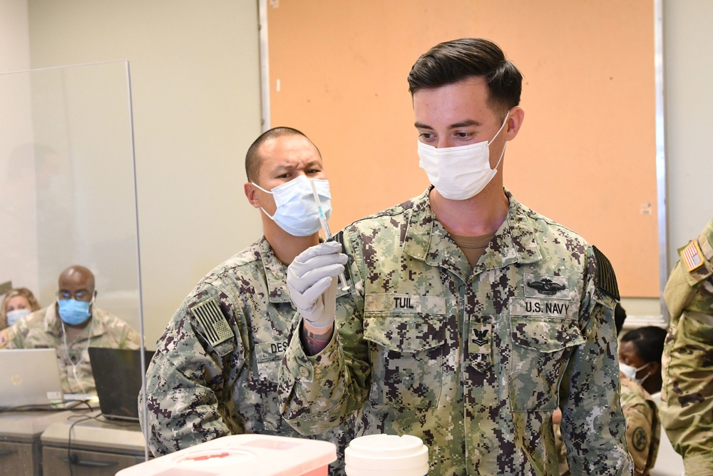 Hospital Corpsman prepares COVID-19 Vaccine at Joint-Service Event