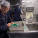 Sailors work in the galley aboard USS Jackson