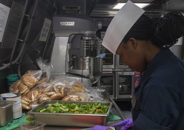 Sailors work in the galley aboard USS Jackson