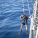 Boatswain’s Mate 3rd Class Martin Sadler, from San Louis Obispo, Calif., is lowered into the water during Search and Rescue (SAR) swimming operations