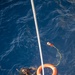 Boatswain’s Mate 3rd Class Martin Sadler, from San Louis Obispo, Calif., retrieves a life ring during Search and Rescue (SAR) swimming operations