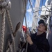 Quartermaster 3rd Class Jordan Boucher, from Worcester, Mass., hoists the Golf flag