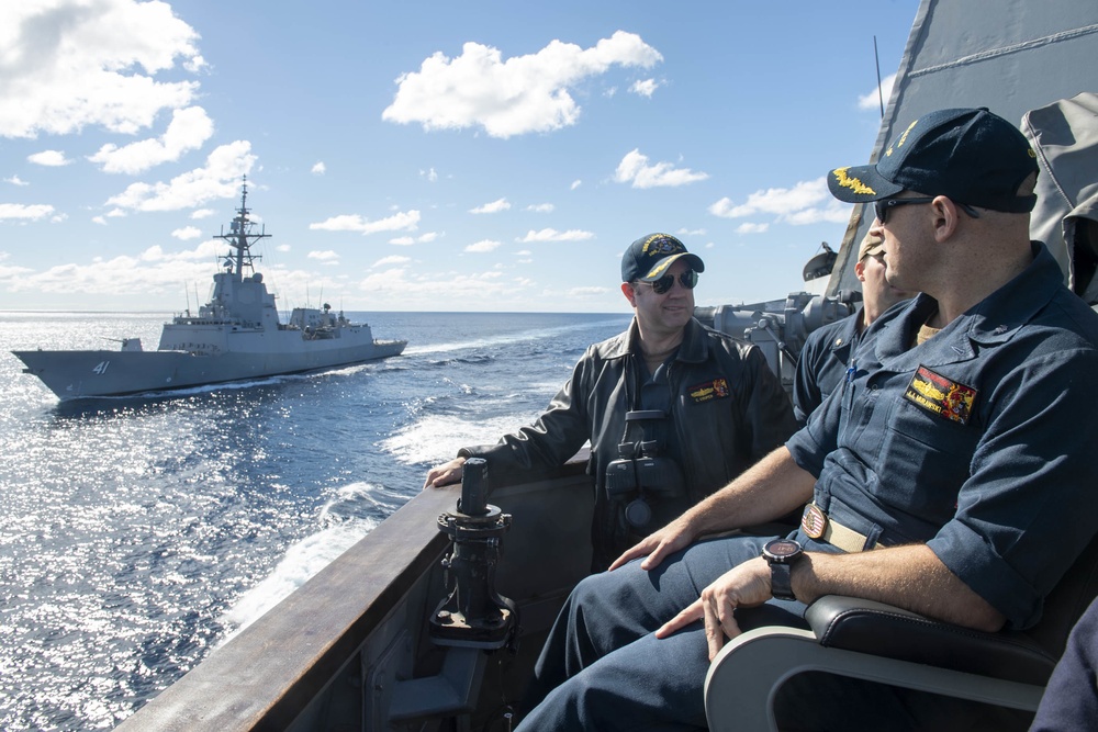 Cmdr. J.J. Murawski (front), commanding officer and Cmdr. Charles Cooper (back), executive officer USS Rafael Peralta (DDG 115) as they sail alongside HMAS Brisbane (FFH 41)