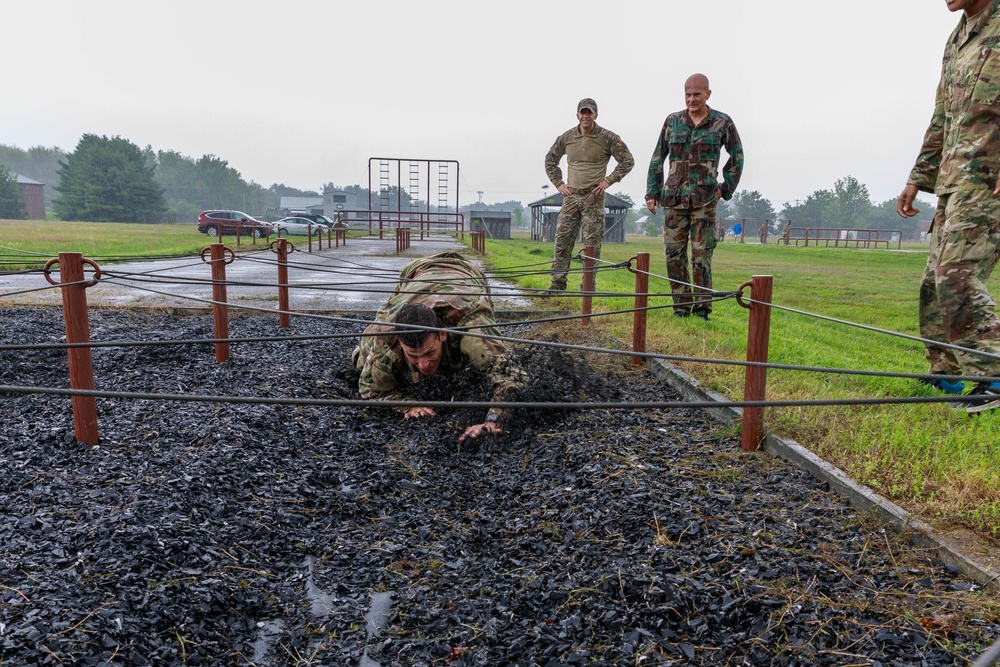 Staff Sgt. Trevor Thompson navigates under an obstacle