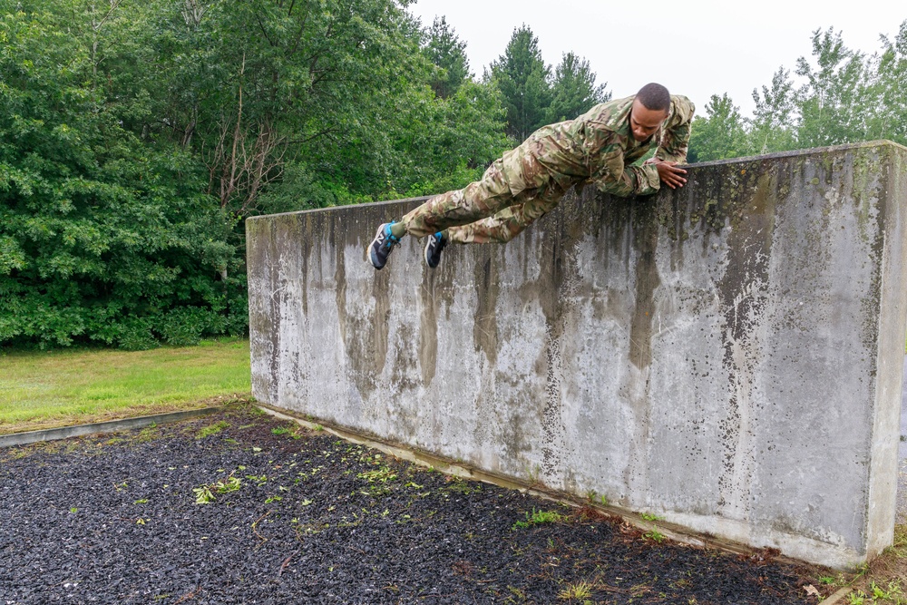 Sgt. Stanley Thompson vaults over an obstacle